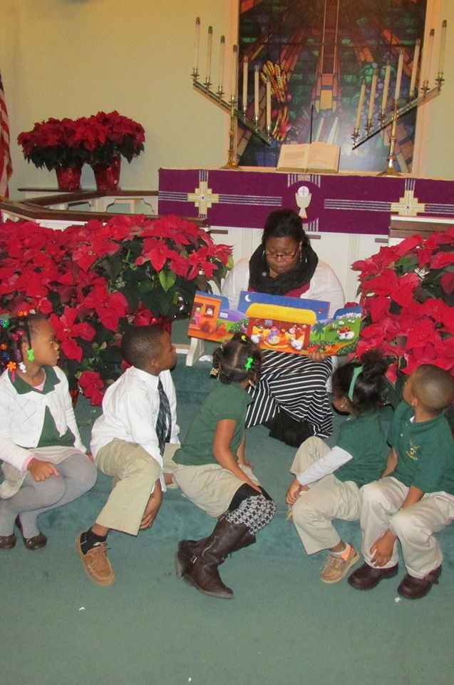 Teacher Sara Bates reading the donated books to her students