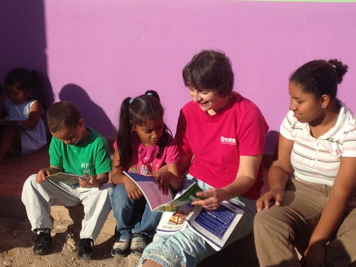 Karen Sue reading to children at the orphanage