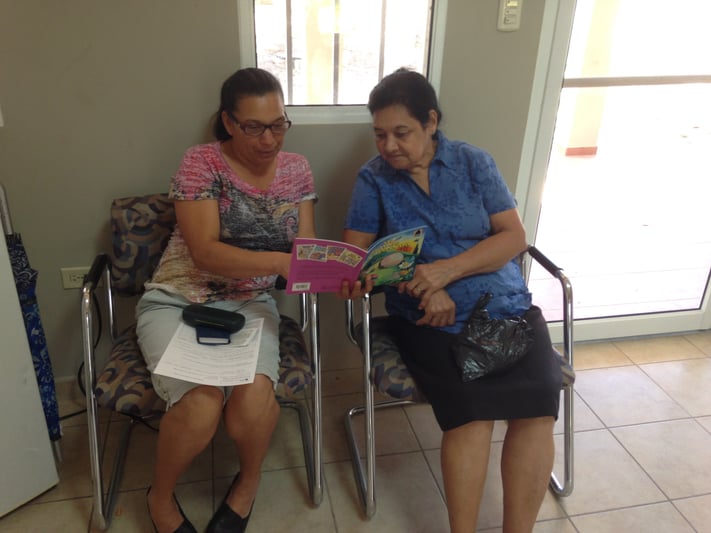 Two women reading a Spanish Arch Book