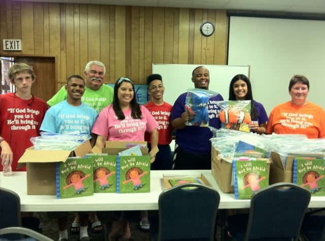 Volunteers packing donated books Volunteers packing donated books