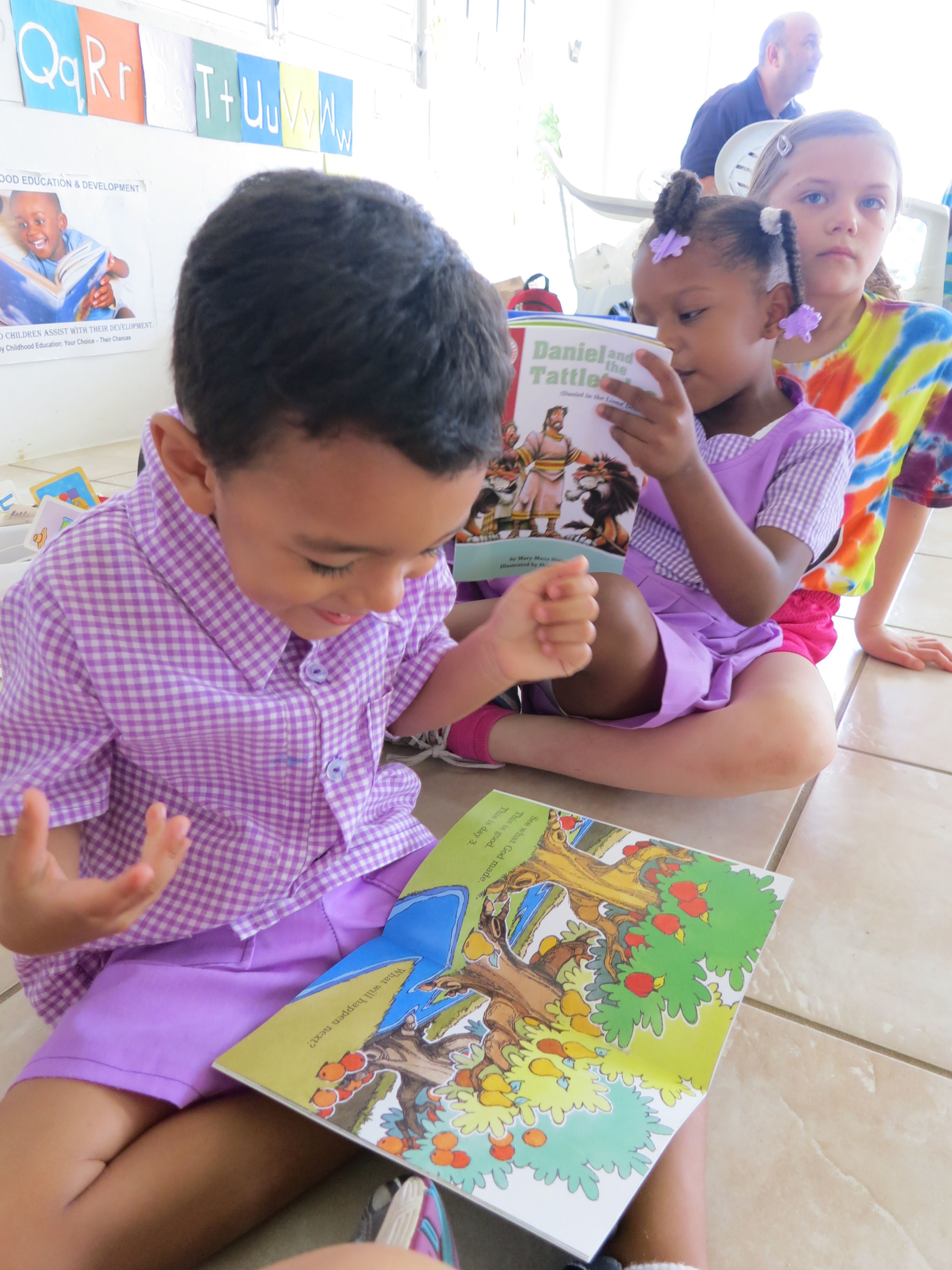 A boy in Belize delights over his new Arch Book!